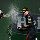 Max Verstappen and Lewis Hamilton spray one another with champagne
